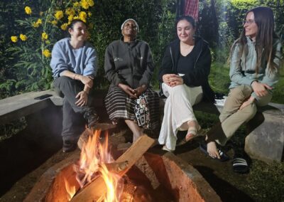 Guests warming themselves by the fire.